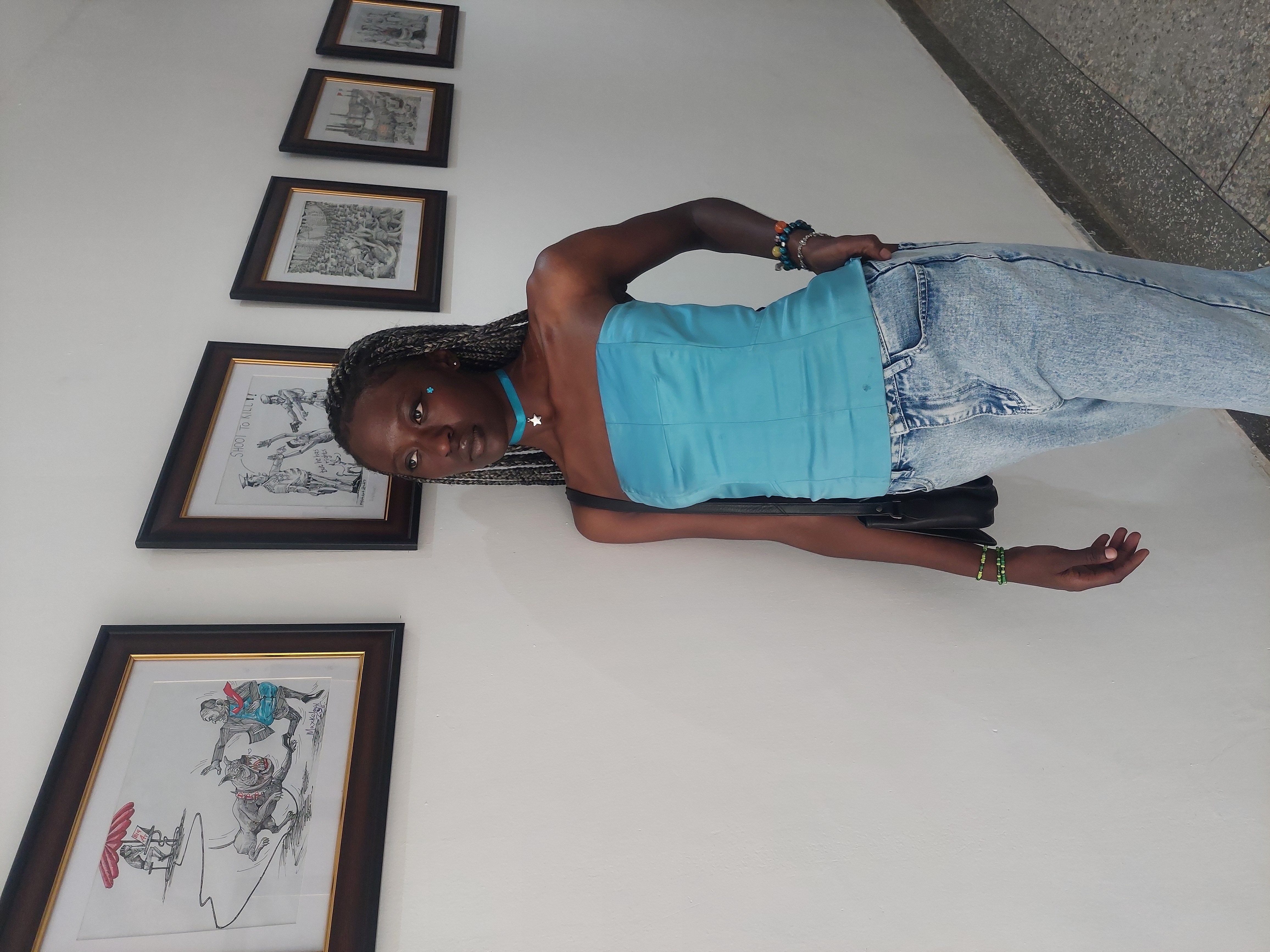 Owirri standing in an art gallery